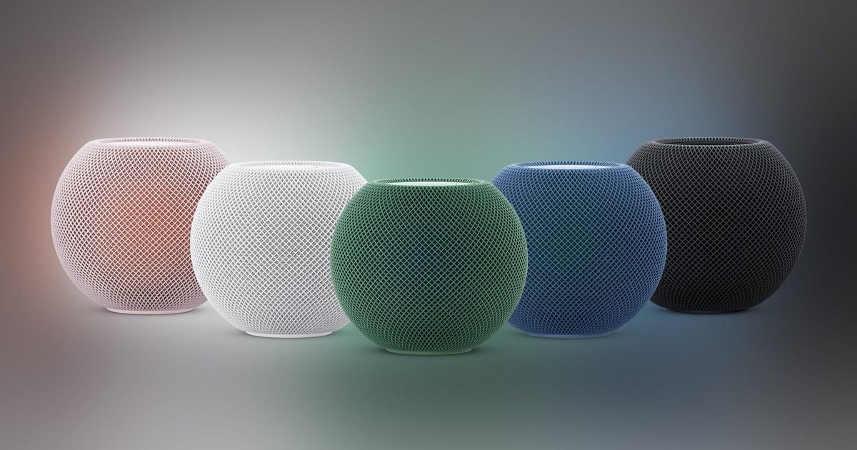 Cinco caixas de som esféricas Apple HomePod mini alinhadas lado a lado nas cores rosa, branca, verde, azul e preta sobre fundo com gradiente